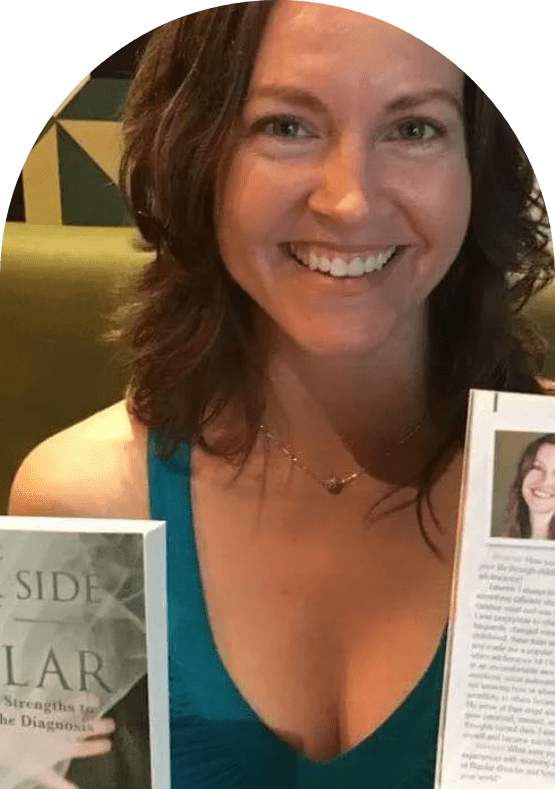 Lauren Polly holding up her multi-award-winning book and a magazine she was featured in at an event in Australia celebrating successful women entrepreneurs.