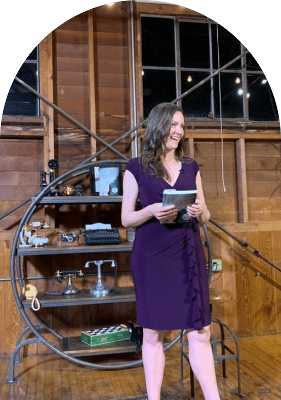 Lauren Polly speaking at a women's entrepreneurial event, holding her book and discussing the importance of using personal stories as a foundation for personal branding.